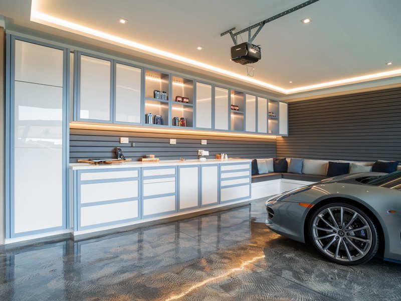 Integrated garage design with custom cabinets and lighting.