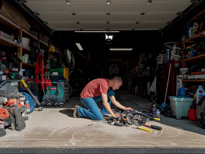 Disorganized garage with tools and car supplies.